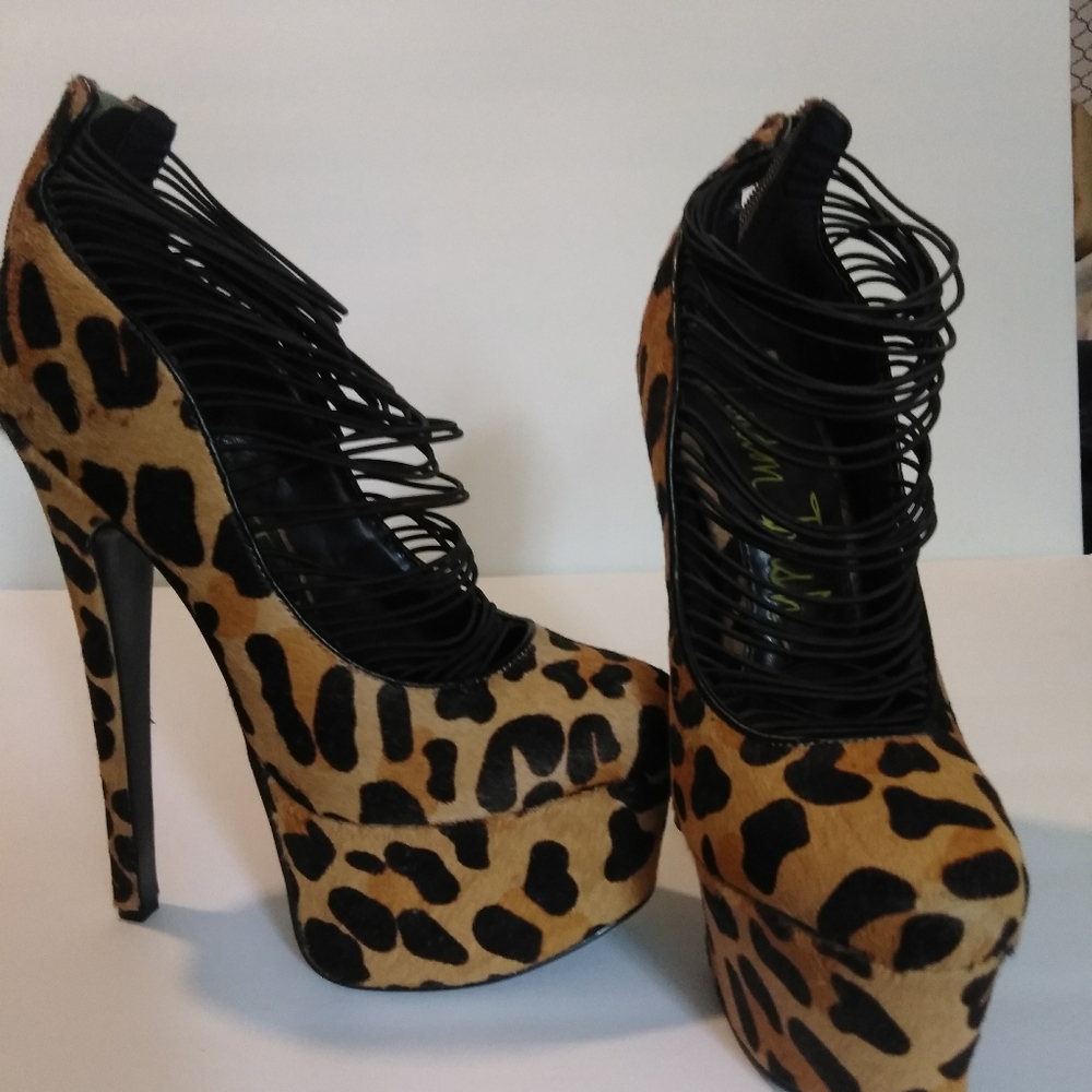 Leopard print 6 inch heels with straps.